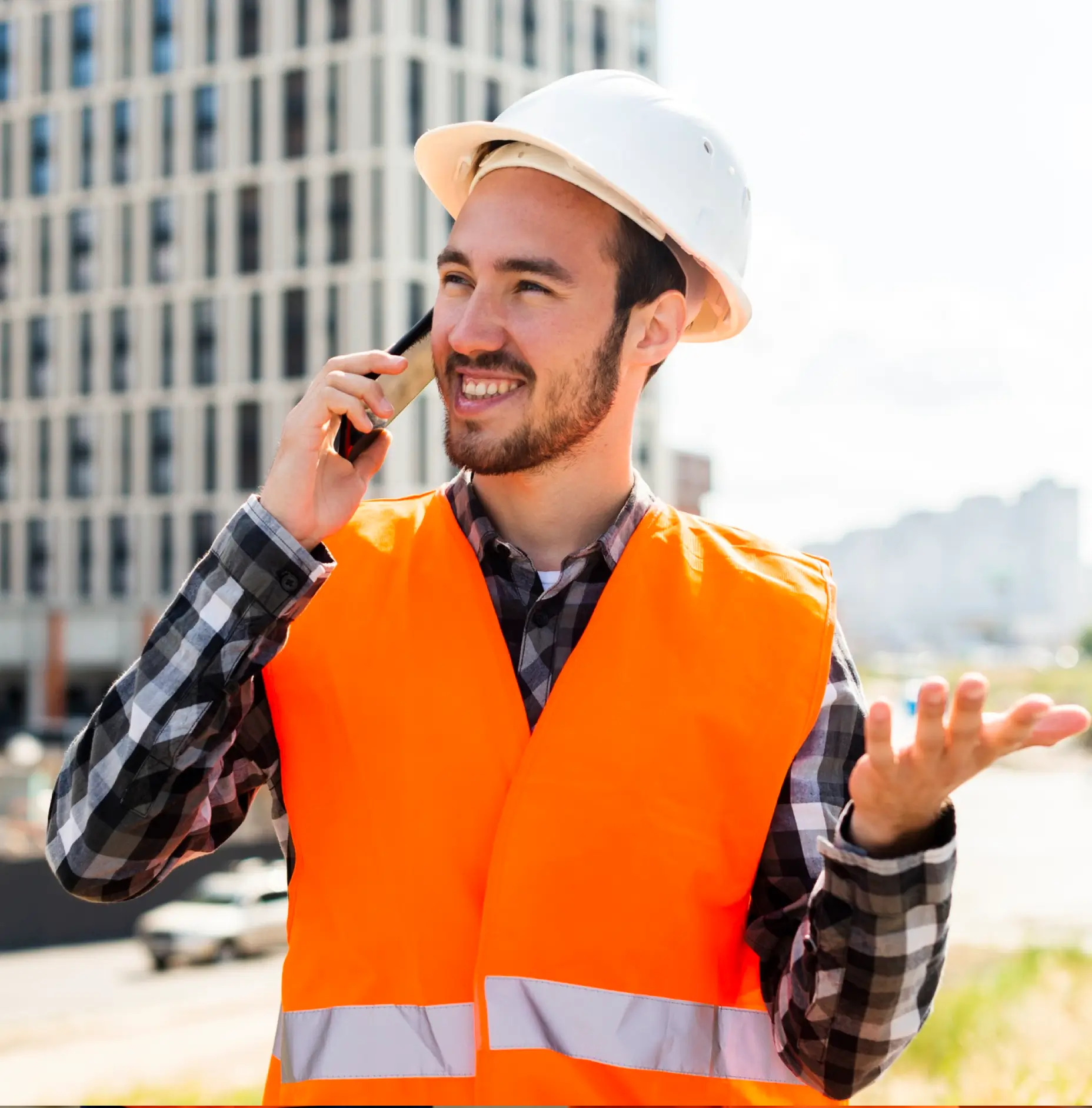 Construction supervisor coordinating on a call at a city construction site